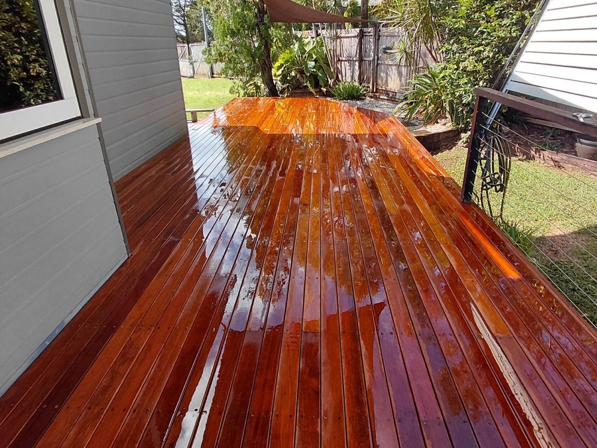 Freshly oiled hardwood decking boards catching the light