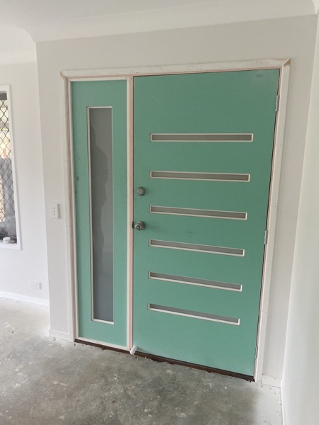 A painted internal door with horizontal timber detailing
